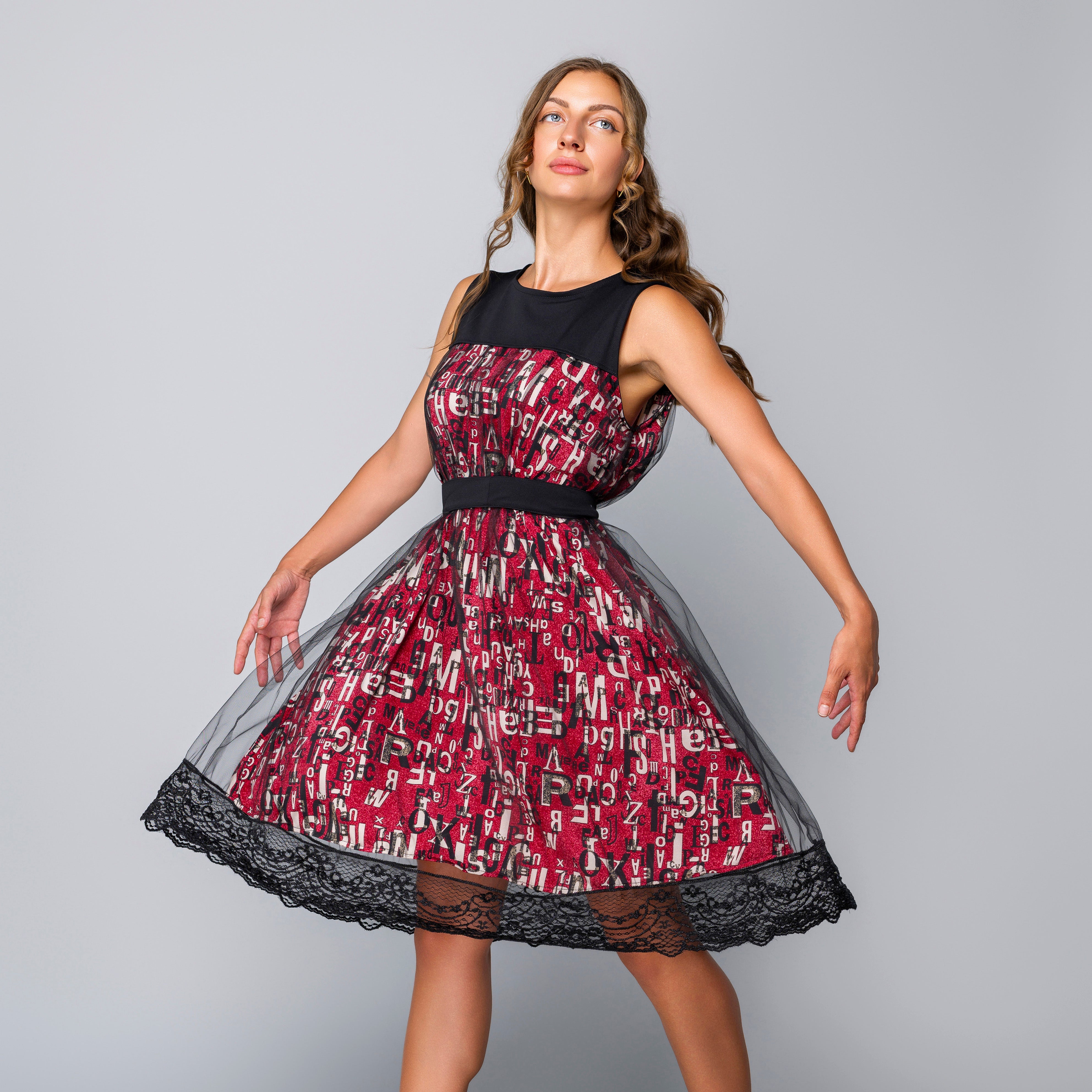 Woman wearing a dress with a red and black pattern on a gray background