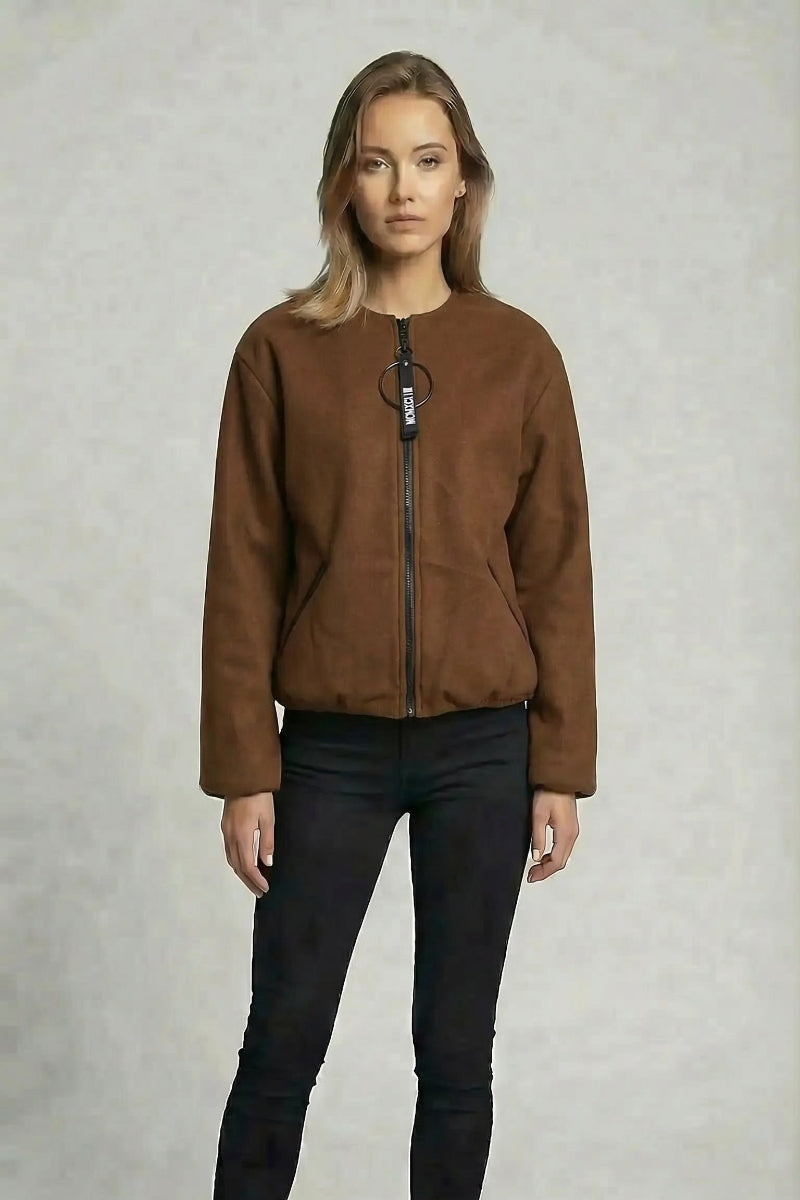 Woman wearing a brown jacket on a gray background